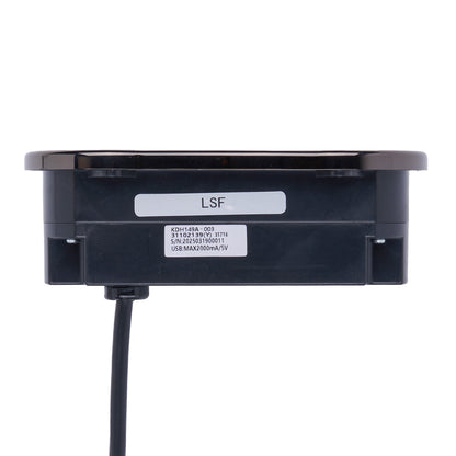 A black rectangular electronic module with a circular top cover, a black power cord extending downward, and two white labels on the front. One label is marked 'LSF' and the other contains technical specifications.